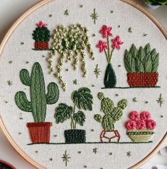 a embroidery project with potted plants and flowers