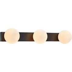 three light bathroom fixture with two white balls on the top and one brown wall mounted