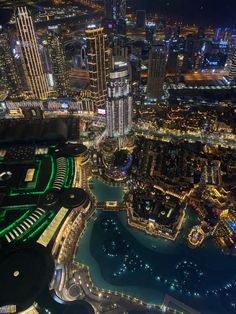 an aerial view of the city lights and buildings at night from high up in the sky