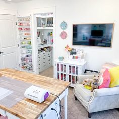 a sewing studio with lots of crafting supplies on the table and in the closet