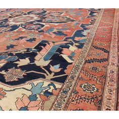 an antique persian rug with blue, pink and orange colors on the carpet is shown