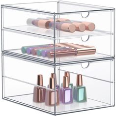 three tiered display case with various nail polishes and cosmetics on it's sides