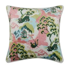 a pink and green pillow with an image of birds in the sky on it's side