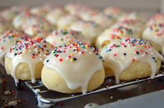 there are many donuts with white frosting and sprinkles on them