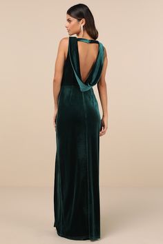 a woman in a long green dress with an open back