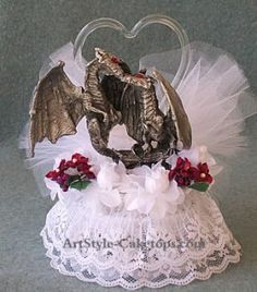 a small figurine in the shape of a dragon on top of a white dress