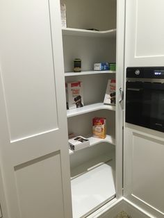 an open pantry door with some food in it