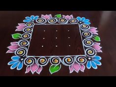 a wooden table topped with a mirror covered in colorful flowers and leaves on top of it