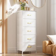 a white chest of drawers sitting next to a window