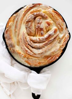 a cast iron skillet filled with cinnamon rolls