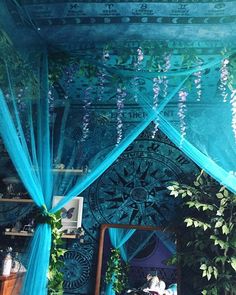 the canopy is decorated with flowers and greenery