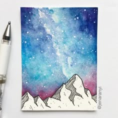 a watercolor painting of the night sky with mountains and stars on it, next to a fountain pen