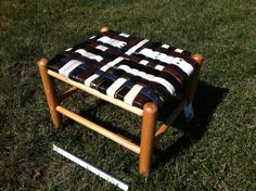 a small wooden stool sitting in the grass