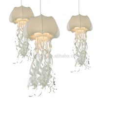 three lights hanging from the ceiling with jelly like material on them, one light is white and