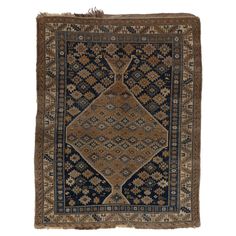 an antique rug with blue, brown and beige designs on it's edges is shown