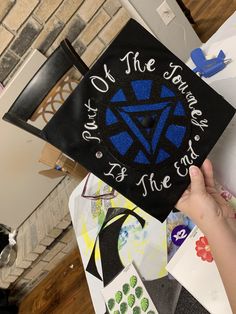 someone holding up a graduation cap with the words on it