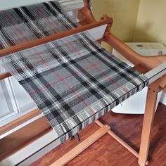 a weaving machine with a plaid cloth on it