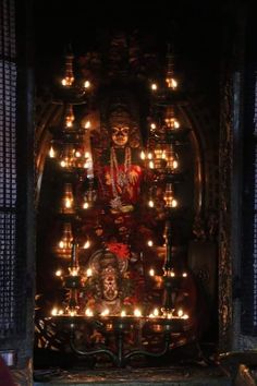 a shrine with candles lit in the dark