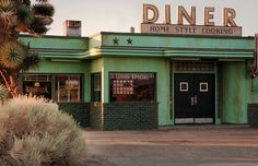 a green building with a sign that says diner home style cooking