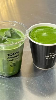 two cups of matcha green tea and one cup with the same drink in it