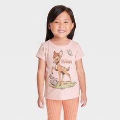 Your child will fawn over this Disney Bambi Short-Sleeve Graphic T-Shirt. The front of this pink pullover tee features an adorable illustration of Bambi, Thumper and a butterfly with the words "Disney Bambi," while the reverse features Flower and two birds. With a crewneck and short sleeves that are perfect for warm weather, the tagless T-shirt is made with a cotton blend that feels comfortable against the skin and is machine washable for easy cleaning. Pink Disney Cotton Top, Pink Cotton Disney Top, Disney Pink Tops With Cartoon Print, Pink Disney Cartoon Print Top, Spring Disney Style Short Sleeve Tops, Nightmare Before Christmas Girl, Bambi Shirt, Bambi Thumper, Disney Clothing