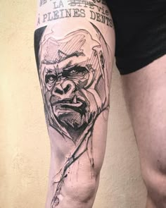 a man with a tattoo on his arm has a drawing of a gorilla and words