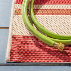 a pair of green hoses sitting on top of a rug