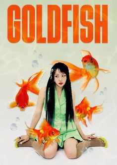 a woman sitting on the ground surrounded by goldfish