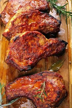 pork chops on a cutting board with herbs