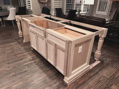 a kitchen island with drawers in the middle