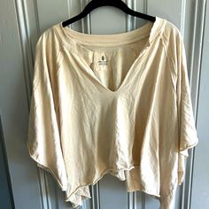 Free People Movement Top, Beige, Size Large. Hole On Back From Tag Being Pulled. Never Worn, Just Washed Beige Relaxed Fit Summer Blouse, Beige Summer Tops For Loungewear, Beige Relaxed Summer Blouse, Neutral Bohemian Tops For The Beach, Bohemian Neutral Tops For Vacation, Neutral Bohemian Tops For Vacation, Beige Cotton Beach Tops, Cream Cotton Top For The Beach, Neutral Cotton Beach Blouse