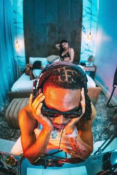 a man with dreadlocks is listening to music