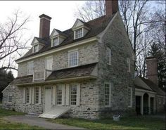 an old stone house with a staircase leading up to it