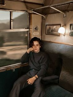 a man sitting in the back of a train car