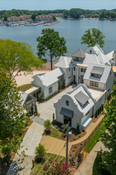 A resplendent, newly-constructed estate on the Lake Norman waterfront, offering 9,700 square feet of modern elegance and access to a tranquil beach. Inside, you’ll find six bedrooms, six full bathrooms, and three powder rooms, along with plenty of common spaces for friends and family to gather and unwind. The house has oversized windows in nearly every room and built-ins like corner banquette seating at a breakfast nook in the kitchen.   18000 Whispering Oaks Drive • Cornelius, North Carolina Corner Banquette Seating, Corner Banquette, Mediterranean Homes Exterior, Desert Town, Stone Farmhouse, Luxury Mansion, Dream Mansion, Oversized Windows, Lake Norman