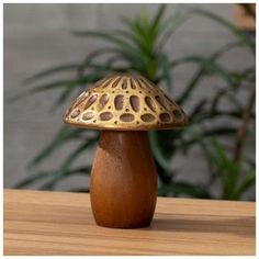 a small wooden mushroom sitting on top of a table