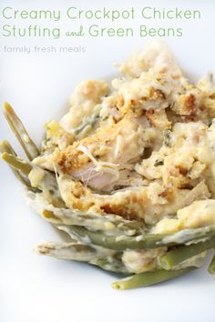 creamy crockpot chicken stuffing and green beans on a white plate with silverware