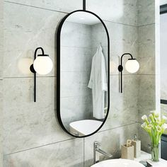 a bathroom sink sitting under a mirror next to a wall mounted faucet with lights on it