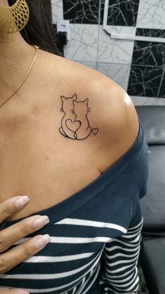 a woman with a cat tattoo on her shoulder