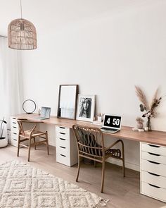 a room with a desk, chair and pictures on the wall next to a window