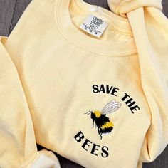 "🐝 Save the Bees Embroidered Crewneck Sweatshirt 🌼 Elevate your style while making a statement for a cause with our exclusive Save the Bees Embroidered Crewneck Sweatshirt! Crafted with comfort and consciousness in mind, this cozy sweatshirt features a unique combination of high-quality materials and a meaningful design to raise awareness about the crucial role bees play in our ecosystem. 🌸 Key Features: Premium Quality: Made from a soft and durable blend of cotton and polyester, ensuring max Bee Outfit, Cute Honey Bee, Bee Shirt, Meaningful Design, Varsity Sweater, Etsy Ideas, Embroidered Crewneck, Sweatshirt Vintage, Etsy Products