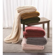 a stack of towels sitting on top of a wooden table