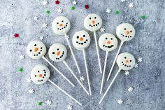 frosted cake pops with snowman faces on them