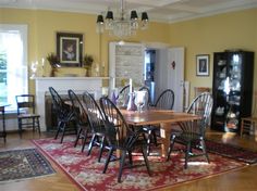 a dining room table with chairs and rug