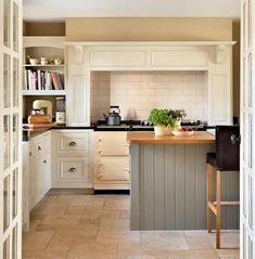 a kitchen with white cabinets and an island