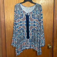 One Worldnwot Blue Colorful Boho Tassel Front Tie Keyhole Shark Bite Hem Bell Sleeve Slouse Size 1x. Excellent New Condition. Tags Were Removed But Never Worn Or Washed. Beautiful Colorway Of Blue/Navy And Colorful Bohemian Print. Has Peplum Ruffle Shark Bite Waistline Hem, Tassel Front Tie Keyhole, And Beautiful Bell Sleeve. This Blouse Has All The Details And Colors. Materials: 96% Viscose 4% Spandex Measurements: (Approximately) Pit To Pit- 23" Length- 35" Ruffle Top Blouses, Geometric Top, Colorful Bohemian, White Short Sleeve Tops, Bohemian Colors, Shark Bites, Bohemian Print, White Halter Maxi Dress, Asymmetrical Tops