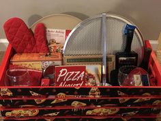 a red box filled with pizza and other items