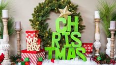 christmas decorations and presents are on display in front of a wall