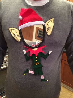 a man wearing a christmas sweater with an elf's hat on his head and eye patch