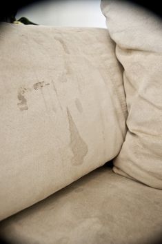 a close up of a pillow on top of a bed with the dust off of it